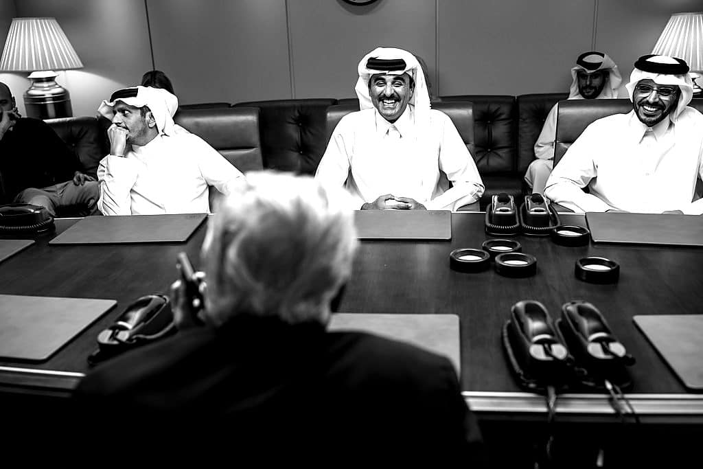 President Trump, seen from behind, meets Qatar's Emir and Prime Minister aboard Air Force One.